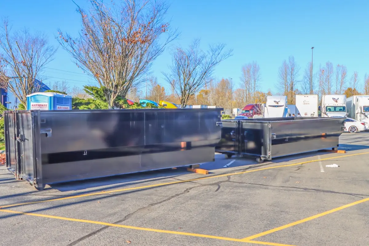 Professional dumpster rental service with roll-off container on residential driveway in Cinnaminson